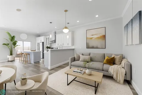a living room with furniture and kitchen view