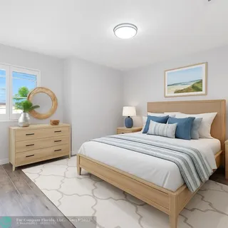 a bedroom with a bed and painting on the wall