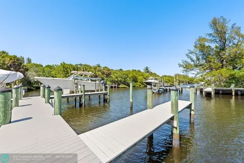 a view of a lake with boats and trees in the background