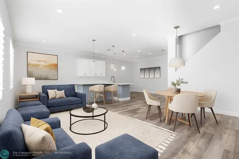 a living room with furniture and a hard wood floor