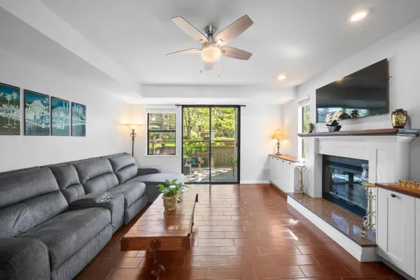 a living room with furniture fireplace and flat screen tv
