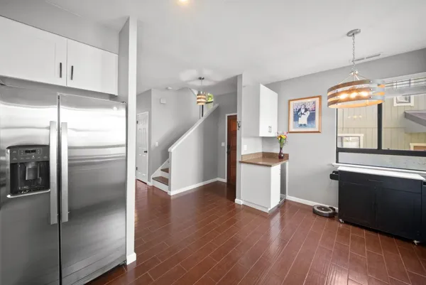 a kitchen with a refrigerator and a sink