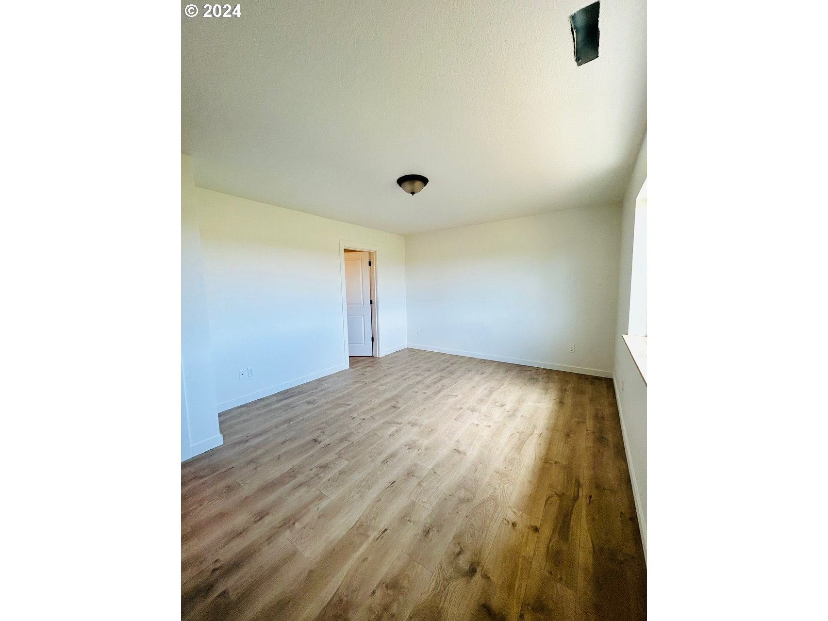 1016 Peach Road Winlock, WA 98596 - Photo 27 of 43 a view of empty room with wooden floor