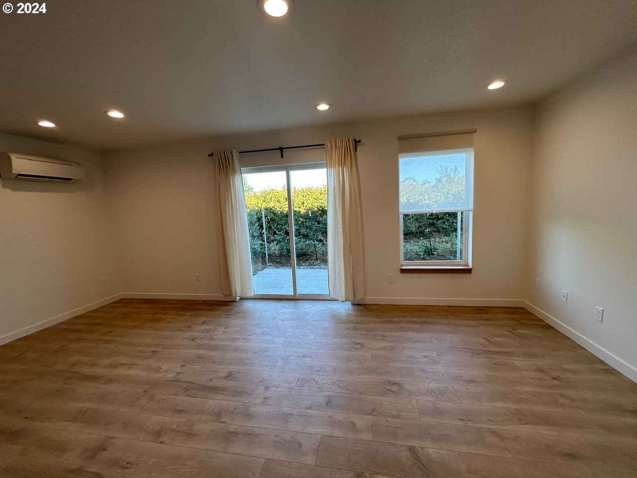 1016 Peach Road Winlock, WA 98596 - Photo 6 of 43 an empty room with wooden floor and windows