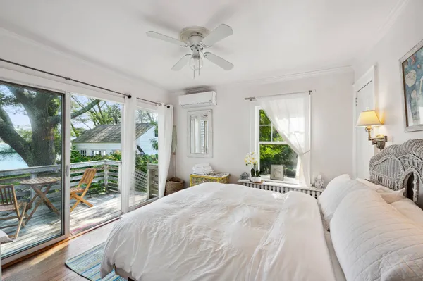 a bedroom with a large bed and a large window