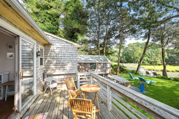 a view of a patio with table and chairs and wooden floor