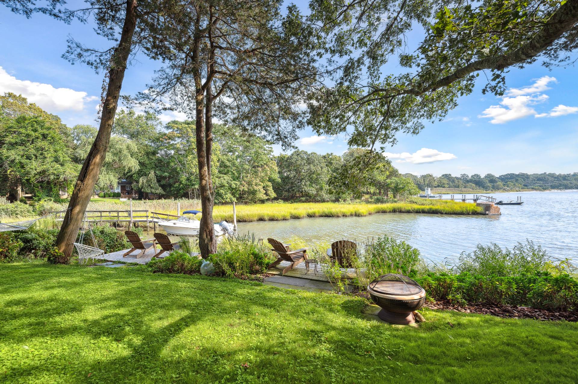64 Towd Point Road Southampton, NY 11968 - Photo 16 of 21 a view of a lake with houses in the back