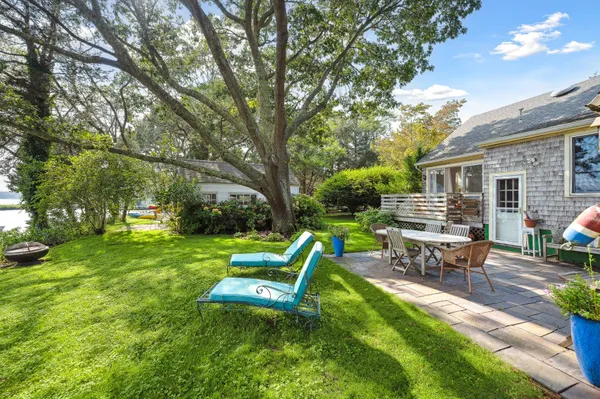 a view of a house with backyard porch and sitting area
