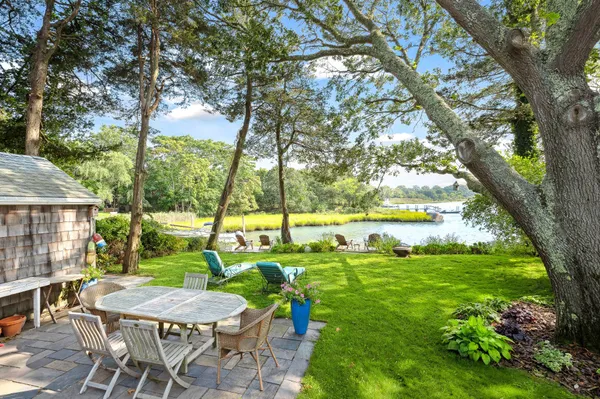 a view of an house with backyard and sitting area