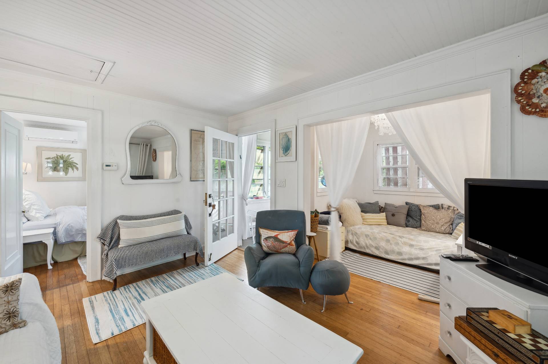 64 Towd Point Road Southampton, NY 11968 - Photo 9 of 21 a living room with furniture and a flat screen tv
