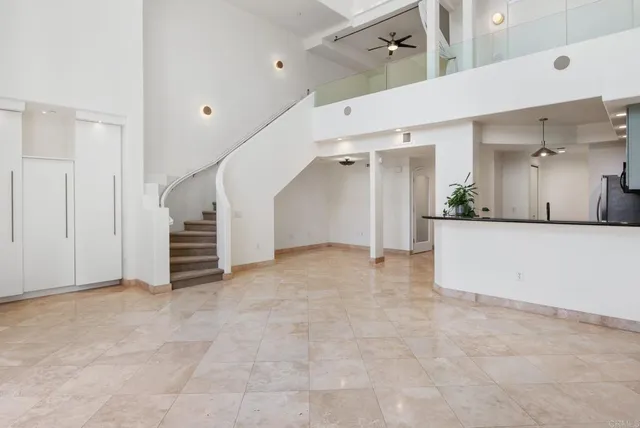 a view of an empty room with a sink and mirror
