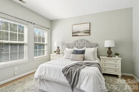a bedroom with a bed and a large window