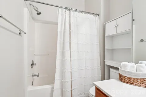 a bathroom with a shower curtain and a sink
