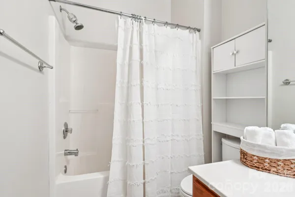 a bathroom with a shower curtain and a sink