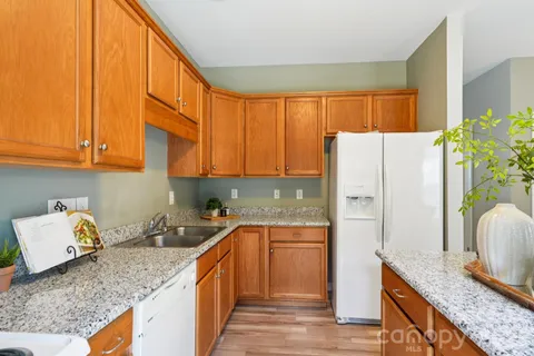 a kitchen with stainless steel appliances granite countertop a refrigerator sink and cabinets