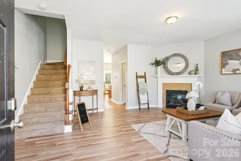 a living room with furniture a fireplace and a table