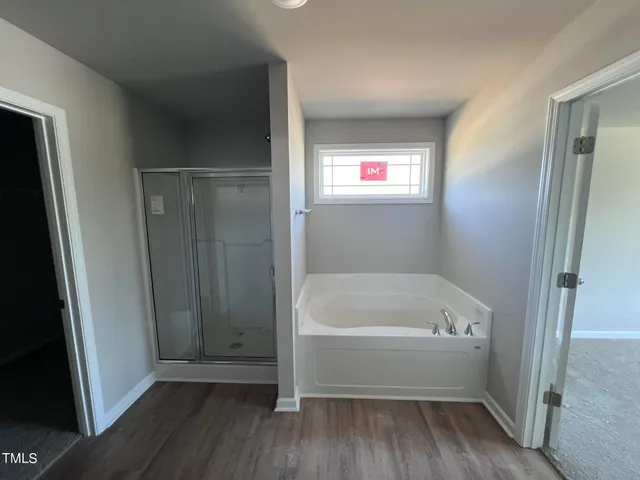 a bathroom with a bathtub and a window