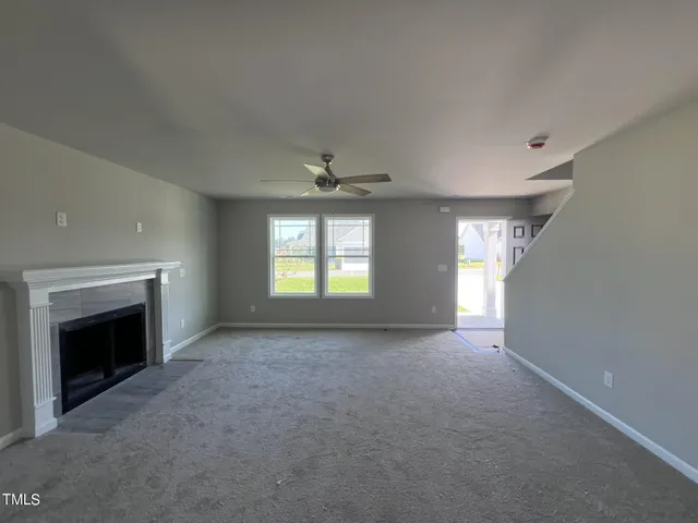 a view of empty room with a fireplace