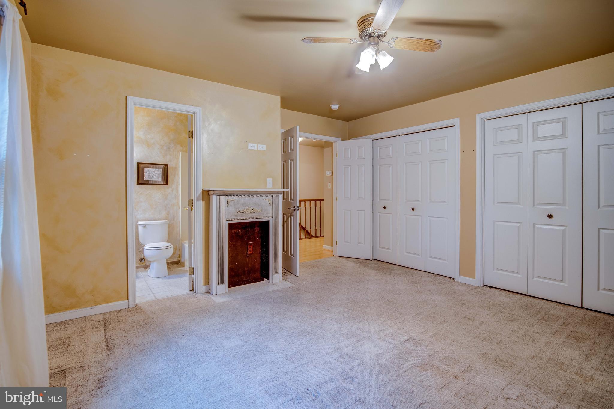 11431 Rawhide Road Lusby, MD 20657 - Photo 26 of 31 an empty room with a fireplace and fan