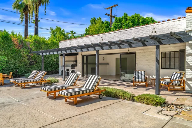 a kitchen with granite countertop a stove a sink and a microwave