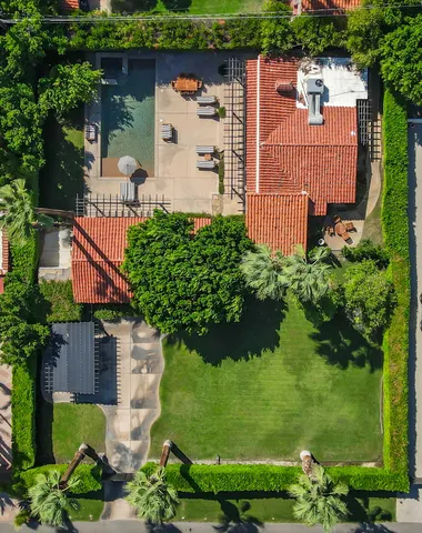 a backyard of a house with plants and tree