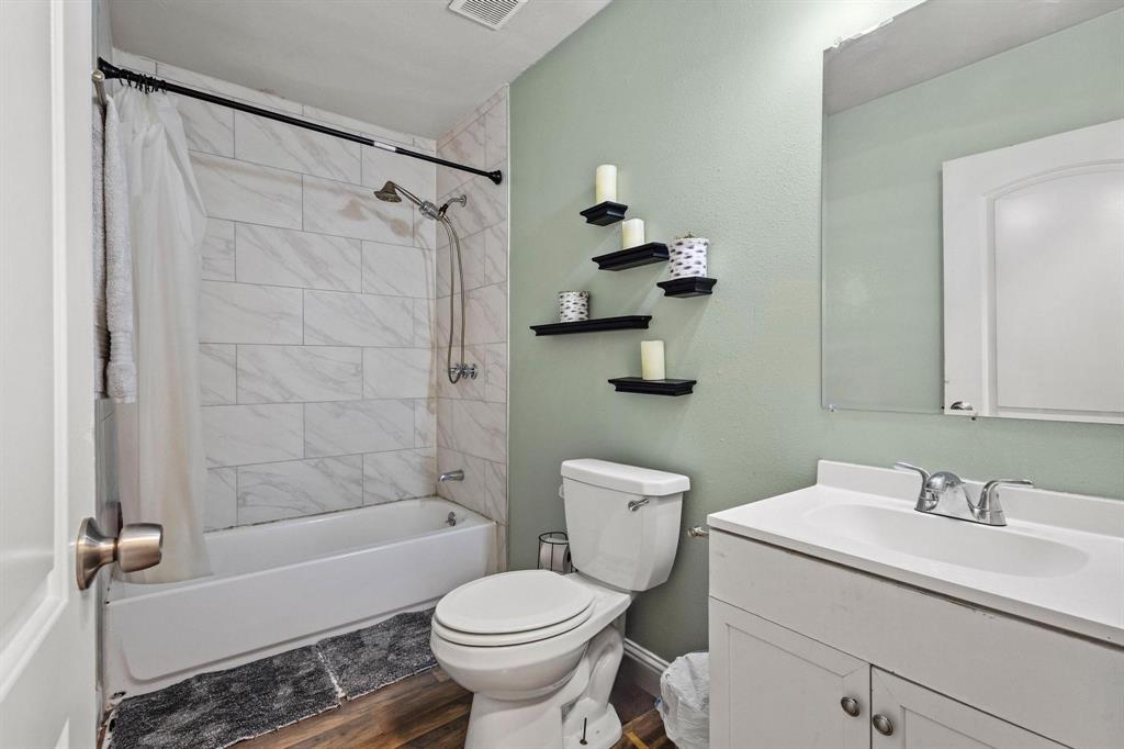 221 Braz Street Bonham, TX 75418 - Photo 17 of 26 a bathroom with a sink toilet and shower