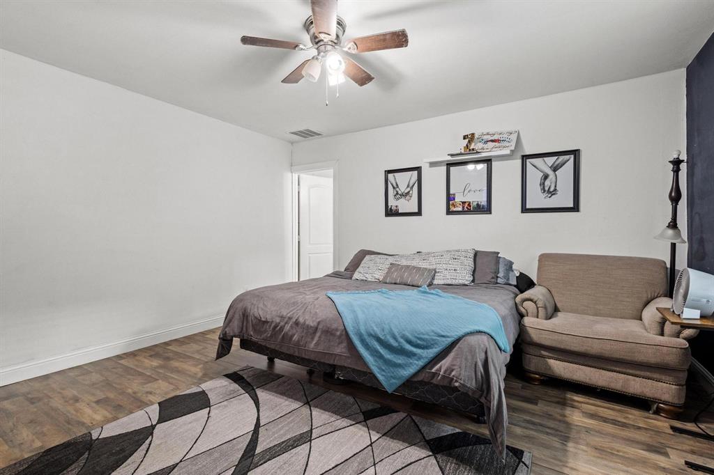 221 Braz Street Bonham, TX 75418 - Photo 20 of 26 a bedroom with a bed and wooden floor