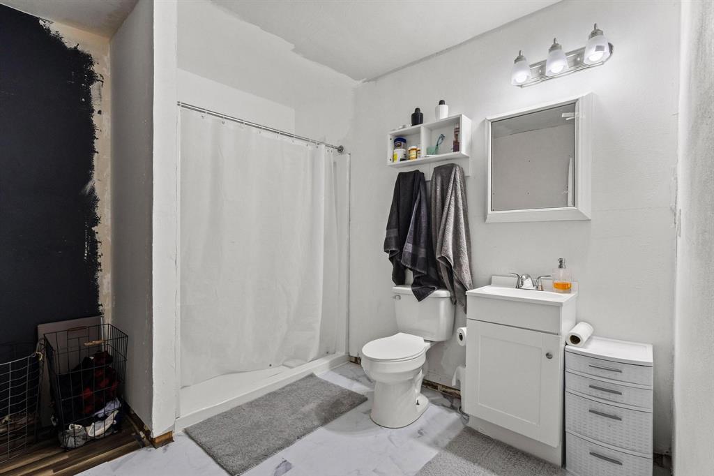 221 Braz Street Bonham, TX 75418 - Photo 21 of 26 a bathroom with a sink toilet and shower