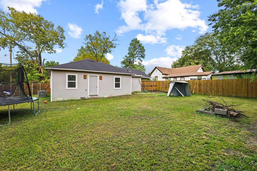 221 Braz Street Bonham, TX 75418 - Photo 24 of 26 a backyard of a house with table and chairs