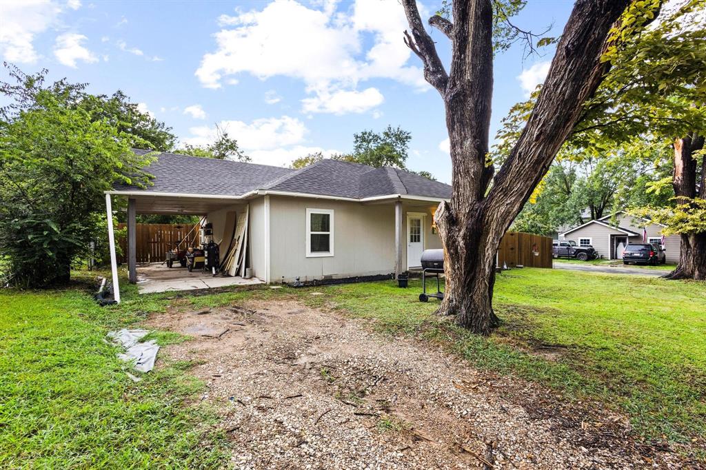 221 Braz Street Bonham, TX 75418 - Photo 3 of 26 a view of a house with a tree in a yard