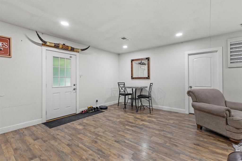 221 Braz Street Bonham, TX 75418 - Photo 7 of 26 a view of a livingroom with furniture and a wooden floor