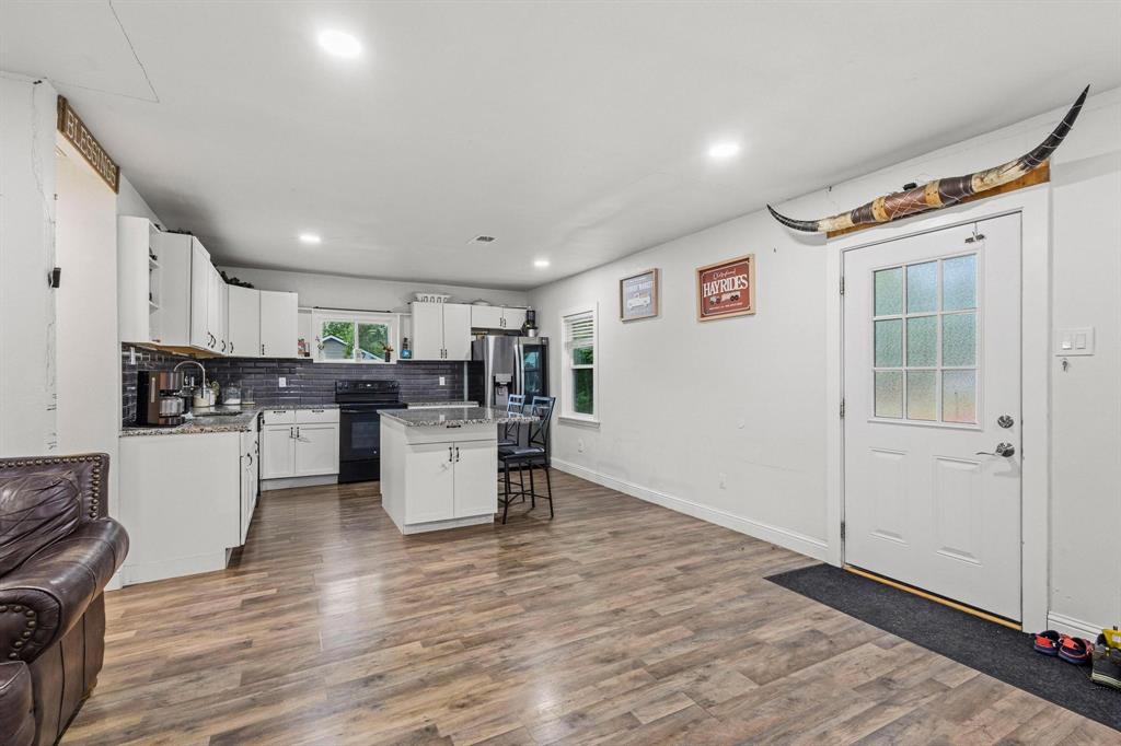 221 Braz Street Bonham, TX 75418 - Photo 26 of 26 a kitchen with stainless steel appliances a refrigerator and a stove top oven