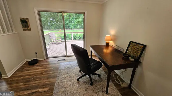 a view of a dining room with furniture and wooden floor