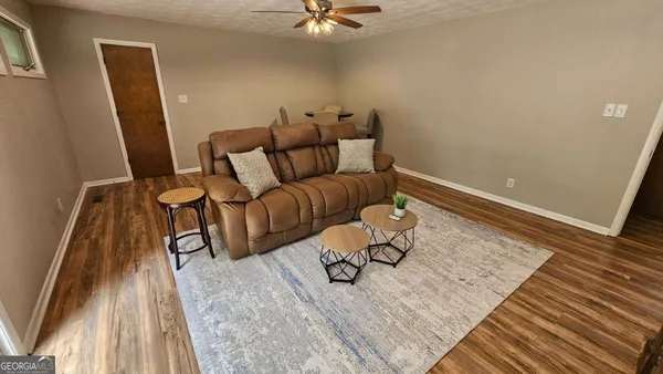 a living room with furniture and a rug
