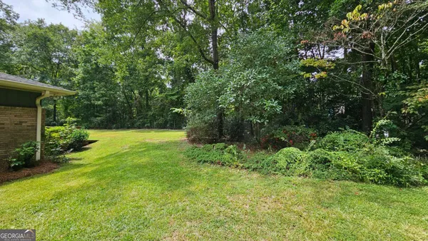 a view of backyard with swimming pool