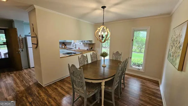 a view of a dining room with furniture window and wooden floor