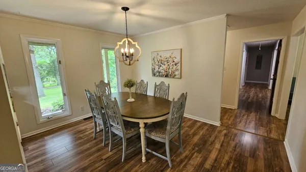 a view of a dining room with furniture window and wooden floor