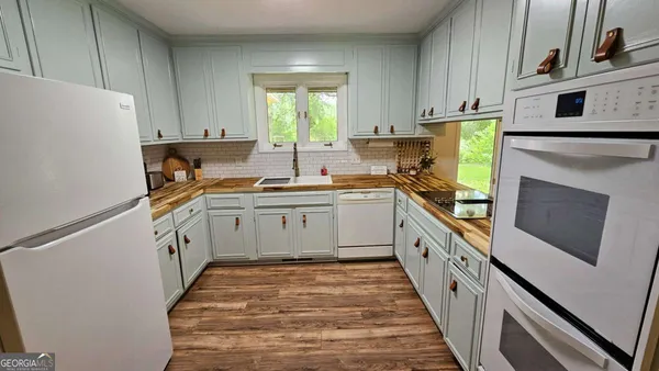 a kitchen with a sink stove and refrigerator