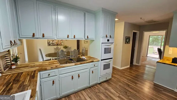 a kitchen with cabinets a sink and appliances