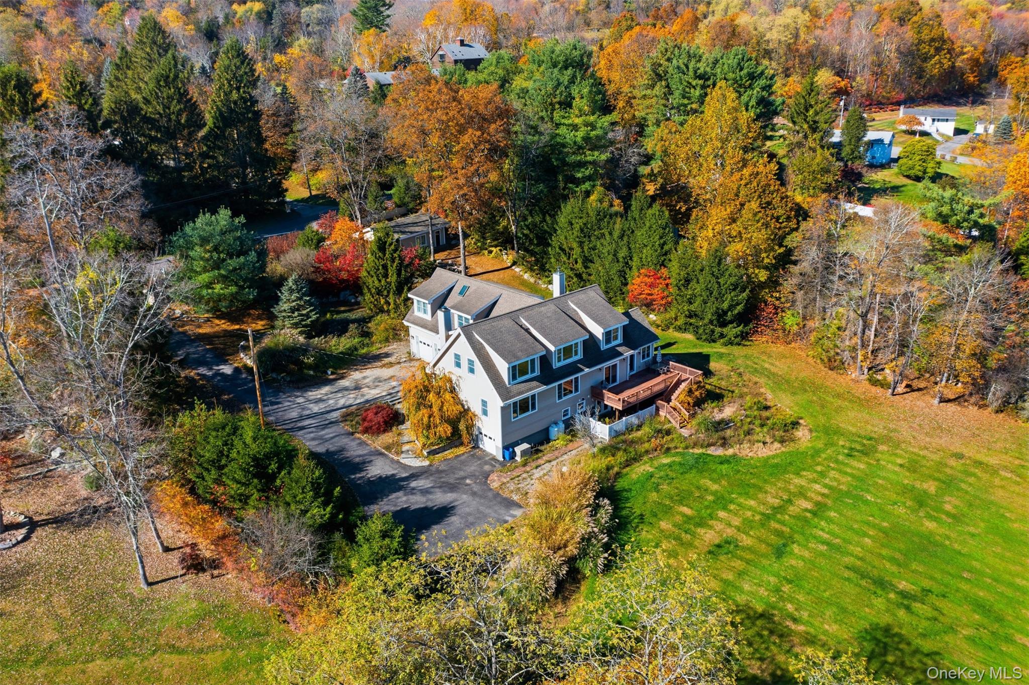 an aerial view of a house with a yard basket ball court and outdoor seating