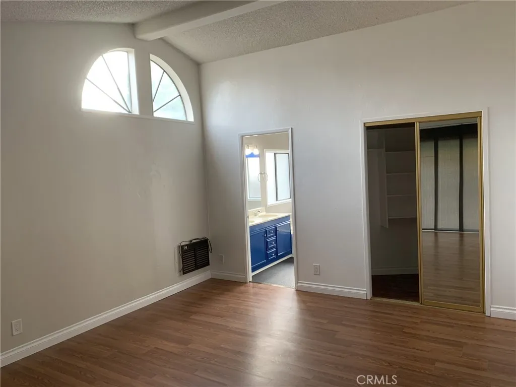 47800 Madison Street Indio, CA 92201 - Photo 12 of 28 an empty room with wooden floor and windows