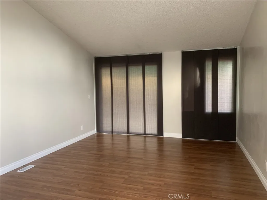 47800 Madison Street Indio, CA 92201 - Photo 15 of 28 a view of an empty room with wooden floor and closet