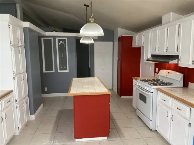 a kitchen that has a cabinets and a stove