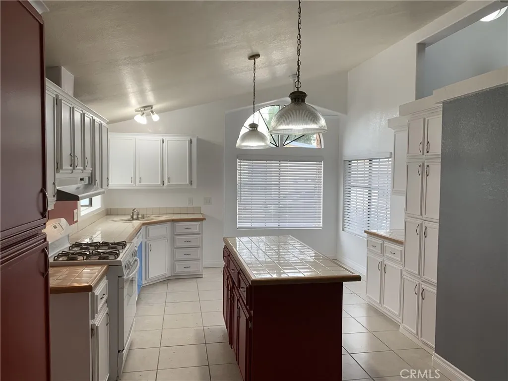 47800 Madison Street Indio, CA 92201 - Photo 22 of 28 a kitchen with a sink stove and cabinets