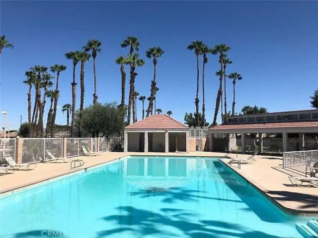 a view of a house with swimming pool and a yard