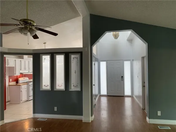 a view of a hallway with wooden floor and entryway