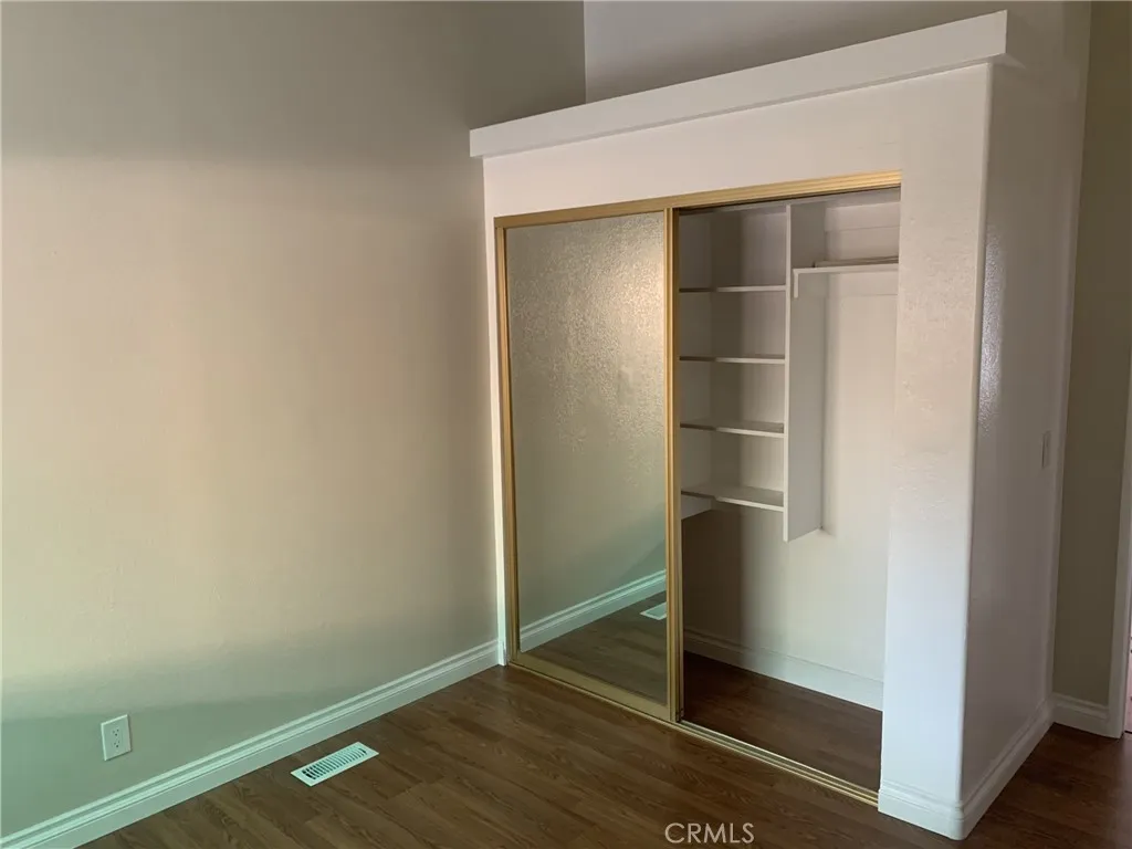 47800 Madison Street Indio, CA 92201 - Photo 7 of 28 a room with wooden floor and closet