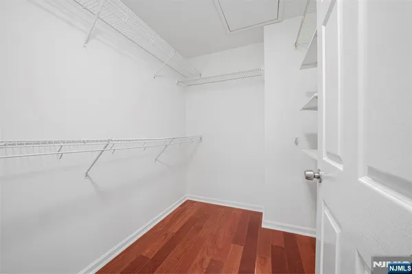 a bathroom with a granite countertop toilet sink and mirror