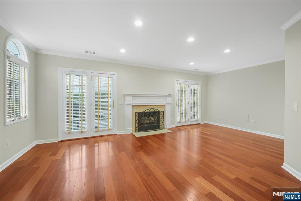 67 Davenport Road Montville, NJ 07045 - Photo 2 of 32 a view of an empty room with wooden floor fireplace and a window