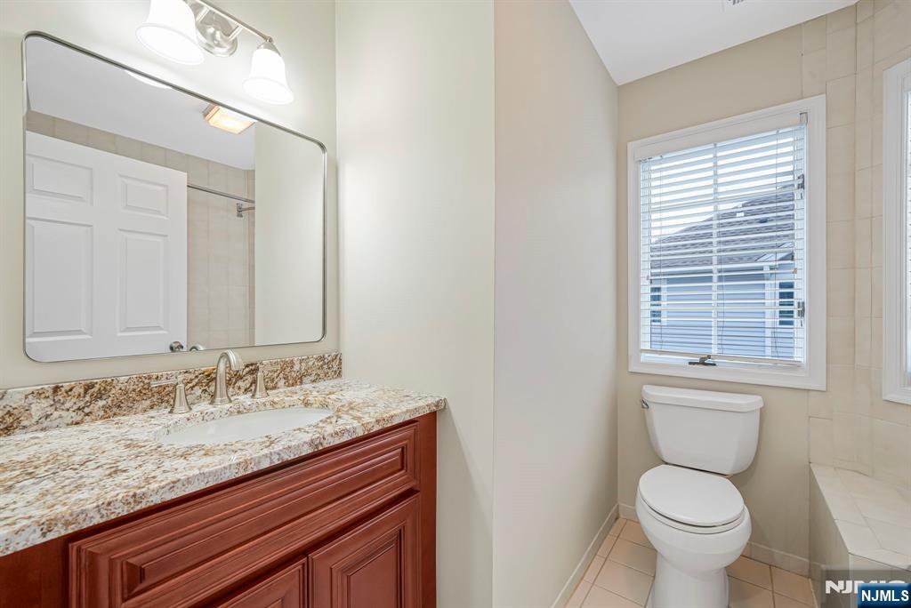 67 Davenport Road Montville, NJ 07045 - Photo 22 of 32 a bathroom with a granite countertop toilet sink and mirror